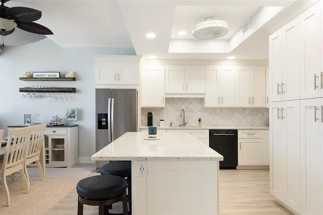a kitchen with a sink a stove and chairs