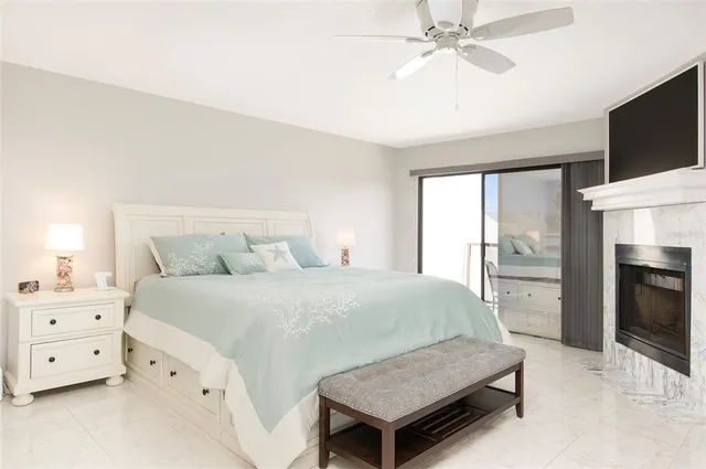 a bedroom with a bed and a flat tv screen on dresser