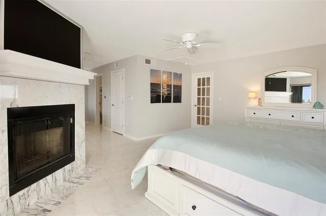 a bedroom with a bed and a fireplace