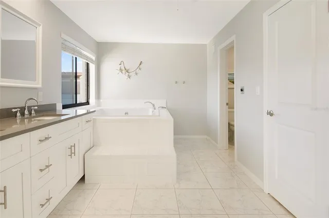 a bathroom with a sink a vanity and a mirror