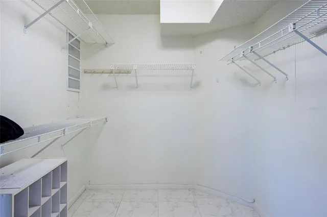 a view of storage and utility room with racks on the wall