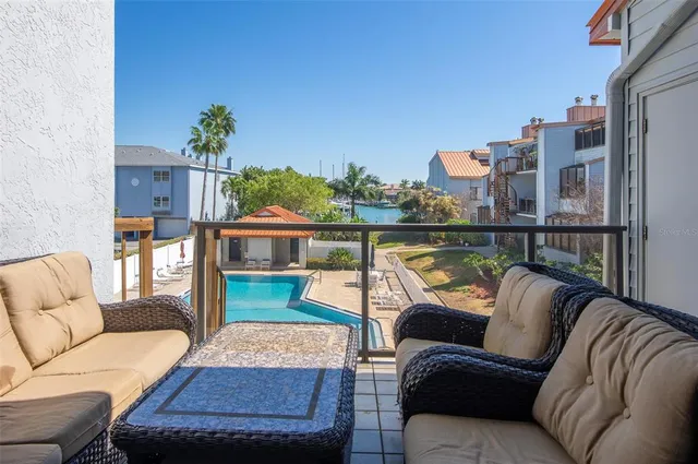 a balcony with wooden floor and furniture
