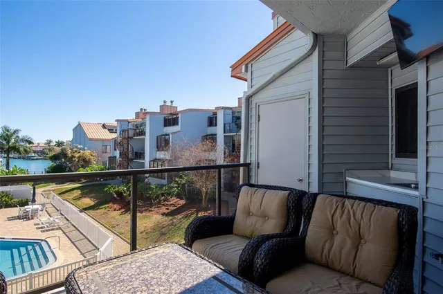 a view of a patio with a table and chairs under an umbrella