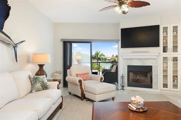 a living room with furniture fireplace and flat screen tv