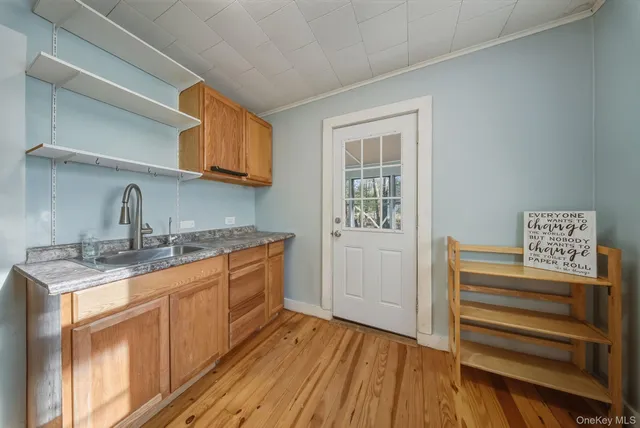a kitchen with granite countertop a sink cabinets stainless steel appliances and a window
