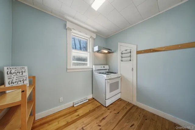 a view of kitchen with sink and refrigerator