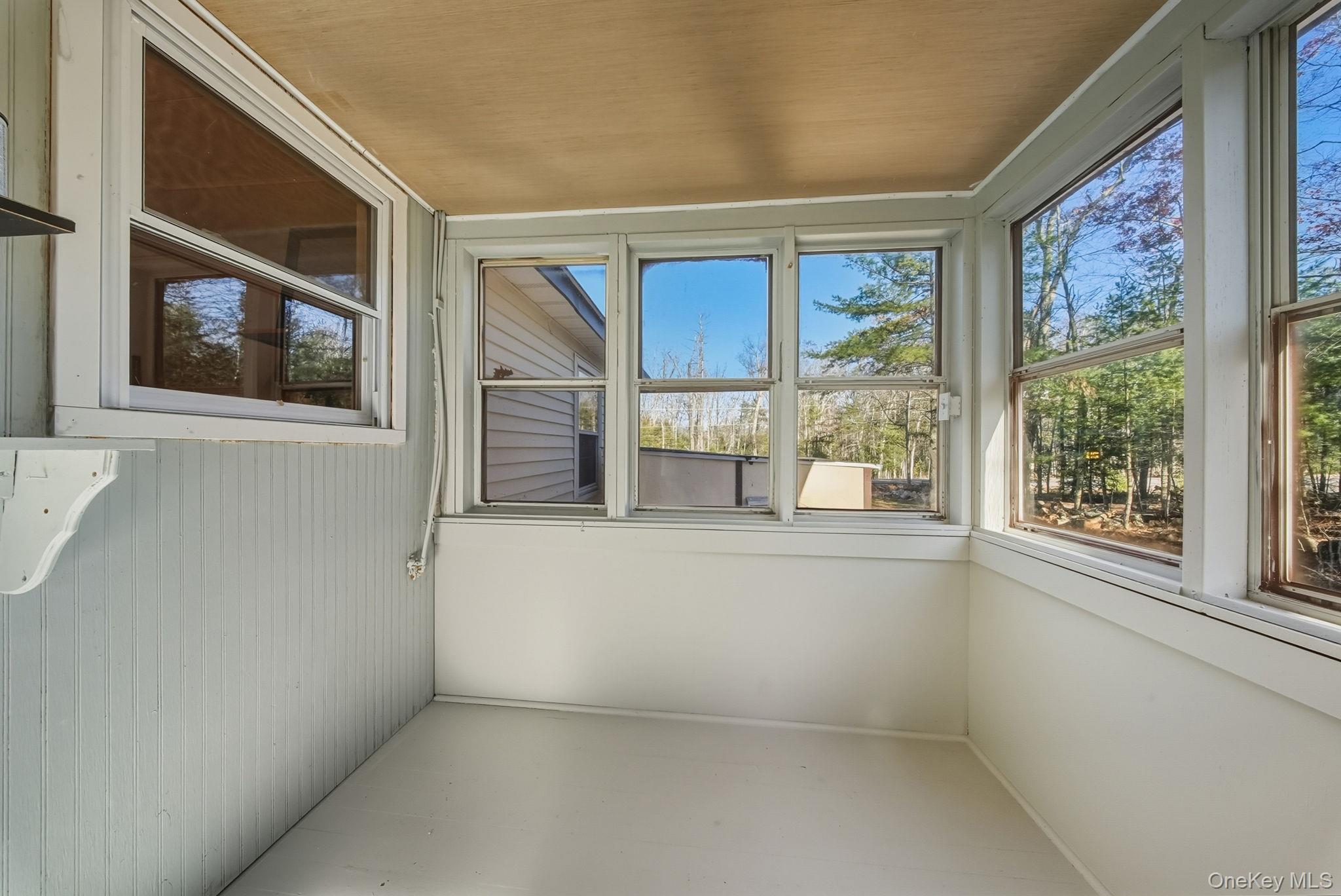 140 Highland Lake Road Highland Lake, NY 12743 - Photo 17 of 34 Unfurnished sunroom featuring wooden ceiling and wooden walls
