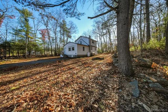 a view of a large house with a yard and large trees