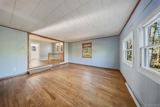 wooden floor in an empty room with a window
