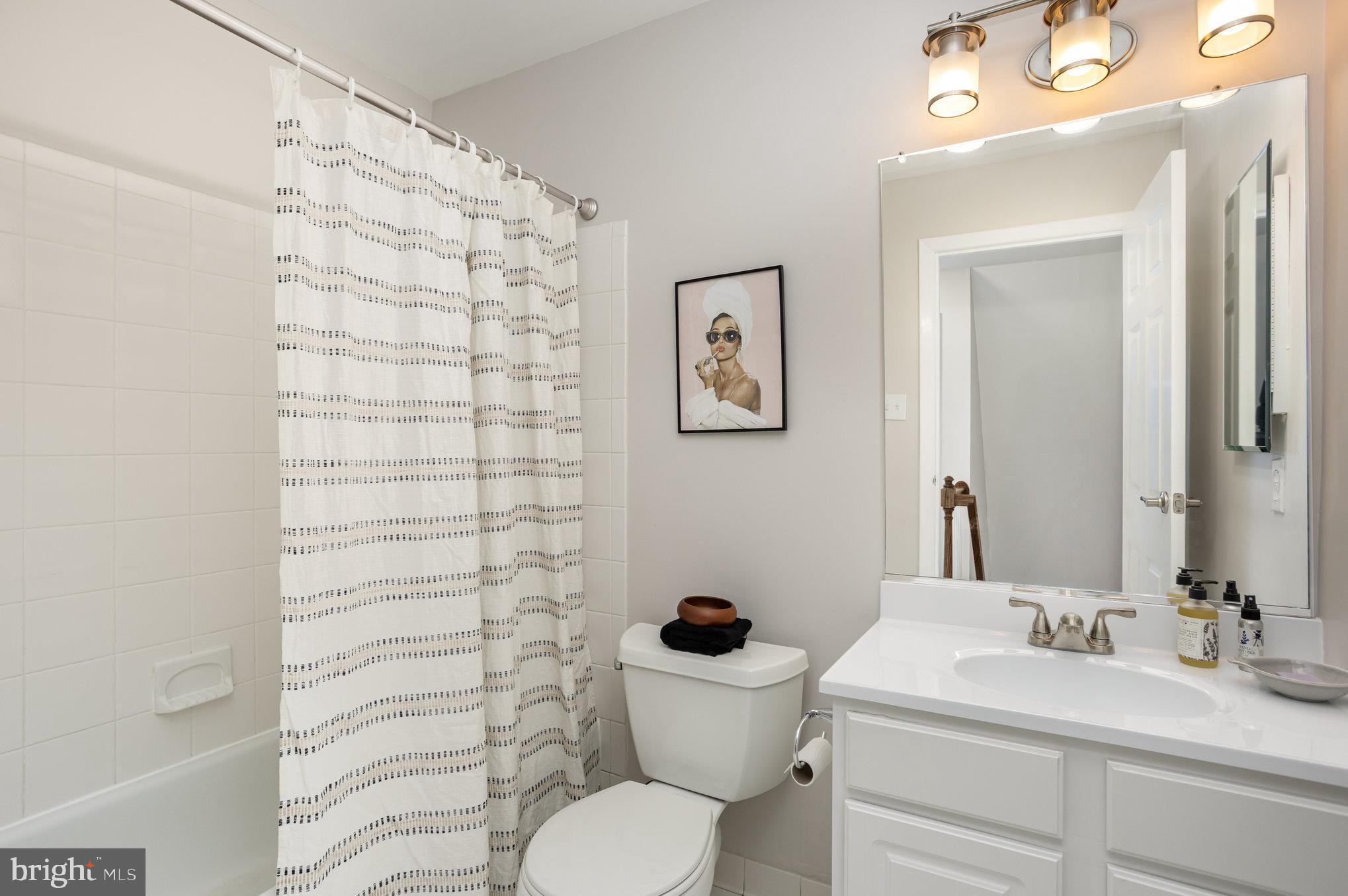 10509 Longbranch Road Cockeysville, MD 21030 - Photo 20 of 38 a bathroom with a sink a toilet and shower curtain