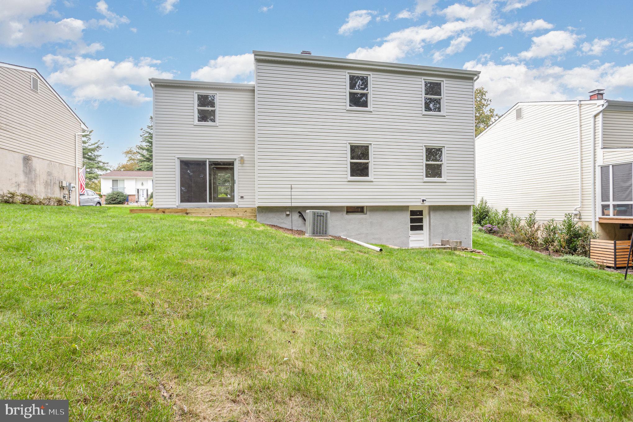 10509 Longbranch Road Cockeysville, MD 21030 - Photo 36 of 38 a view of a backyard with plants and a large tree