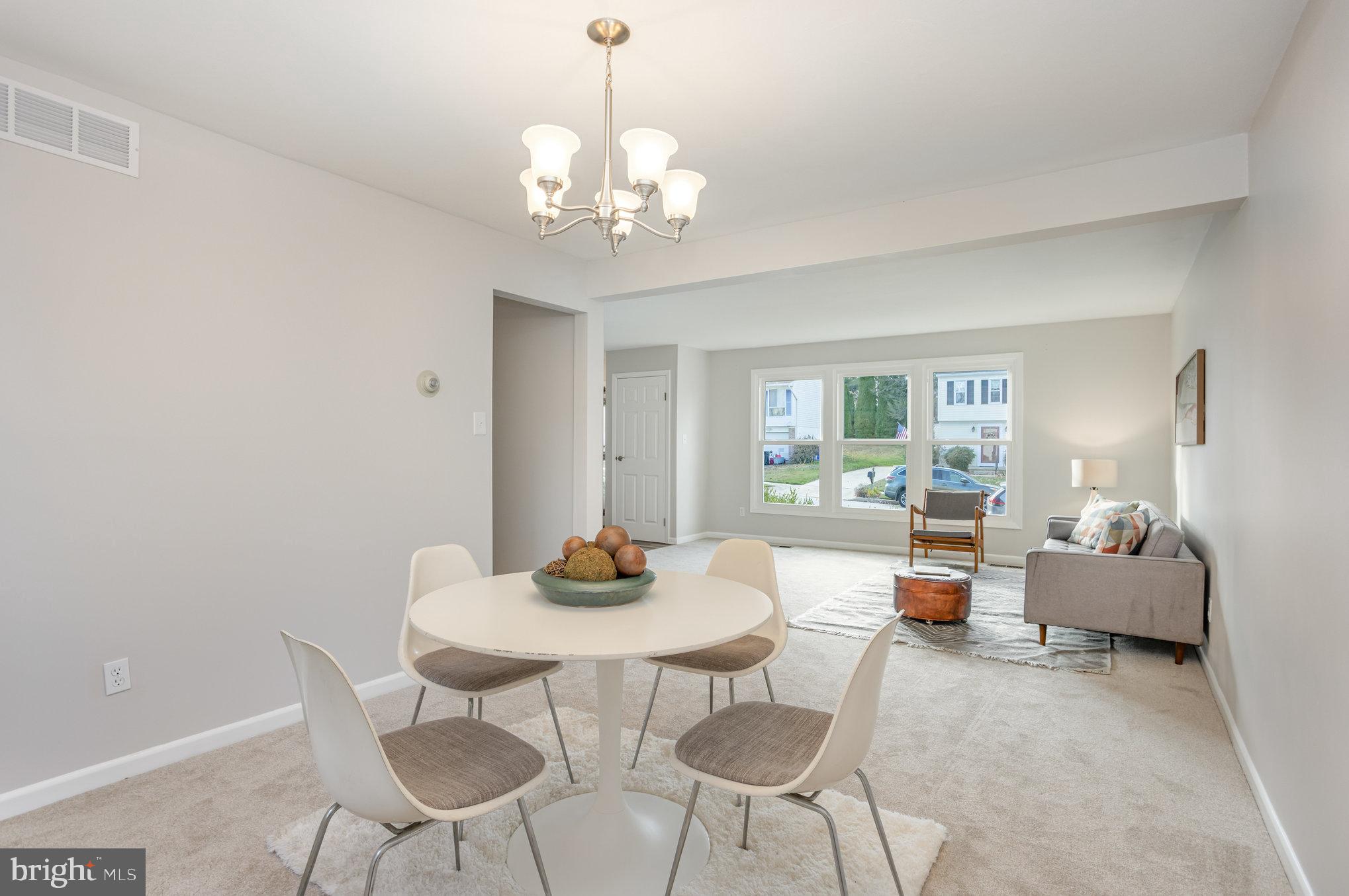 10509 Longbranch Road Cockeysville, MD 21030 - Photo 7 of 38 a view of a dining room with furniture a chandelier and wooden floor