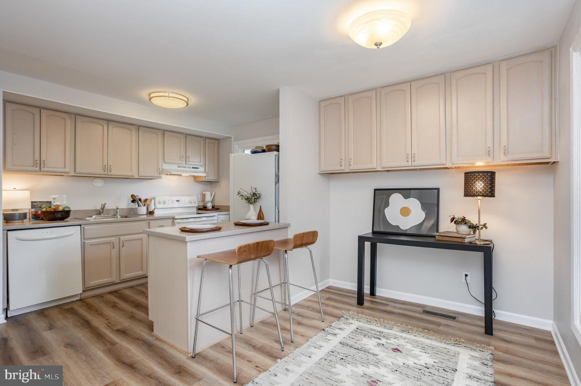 10509 Longbranch Road Cockeysville, MD 21030 - Photo 9 of 38 a kitchen with stainless steel appliances granite countertop a stove a sink and a white cabinets