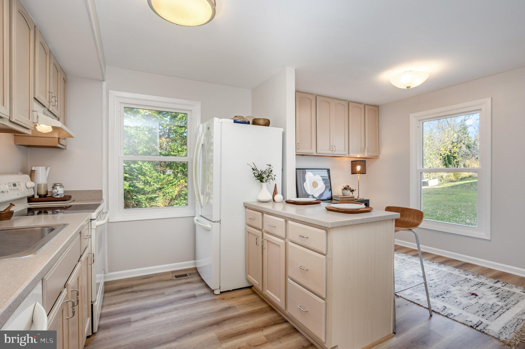 10509 Longbranch Road Cockeysville, MD 21030 - Photo 10 of 38 a kitchen with a stove a sink and a window