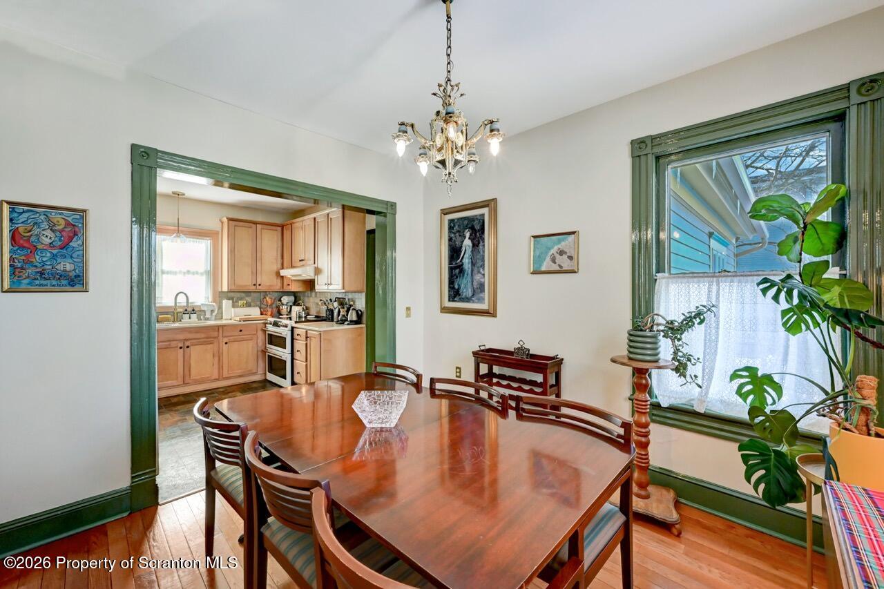 902 Columbia Street Scranton, PA 18509 - Photo 19 of 66 a dining room with furniture potted plants and wooden floor