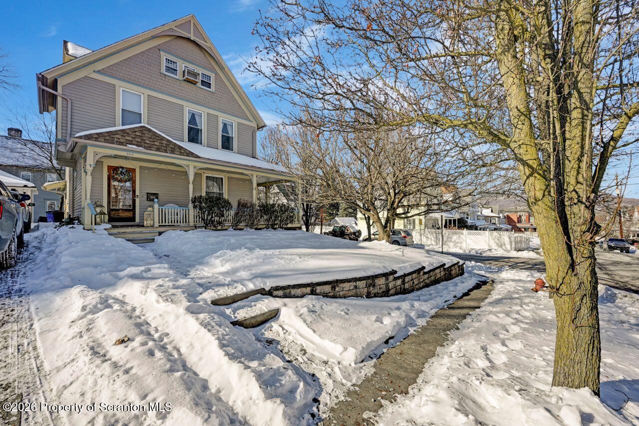902 Columbia Street Scranton, PA 18509 - Photo 2 of 66 a view of a white house with a yard covered in snow