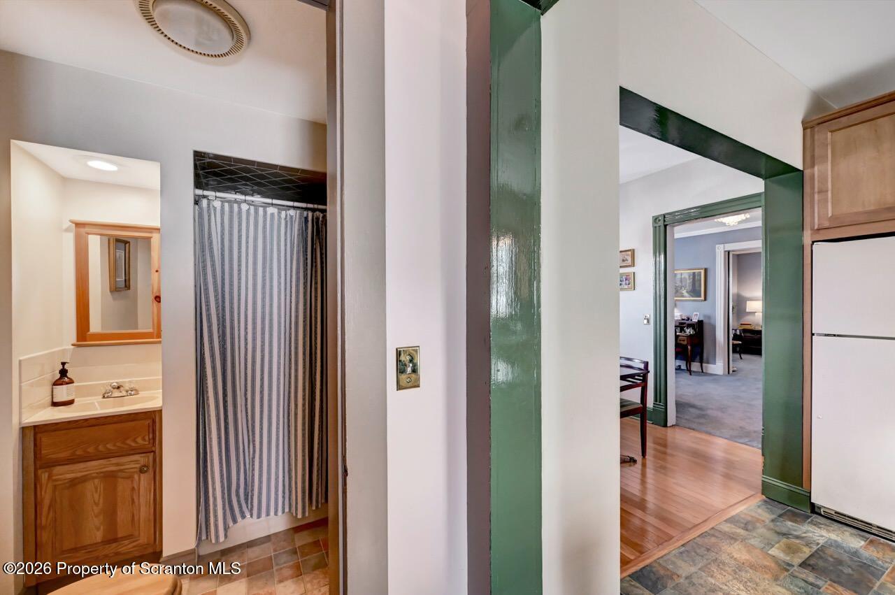 902 Columbia Street Scranton, PA 18509 - Photo 25 of 66 a view of a hallway with dining room and wooden floor