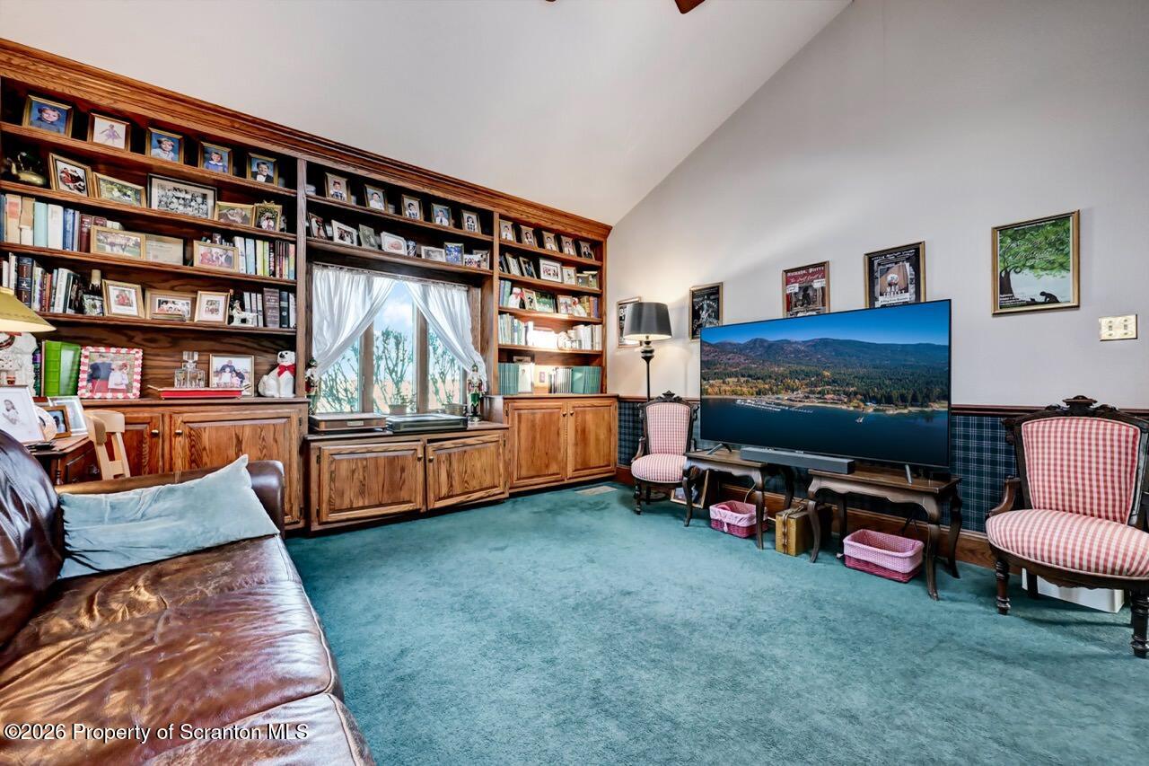 902 Columbia Street Scranton, PA 18509 - Photo 29 of 66 a living room with furniture a rug and a bookshelf