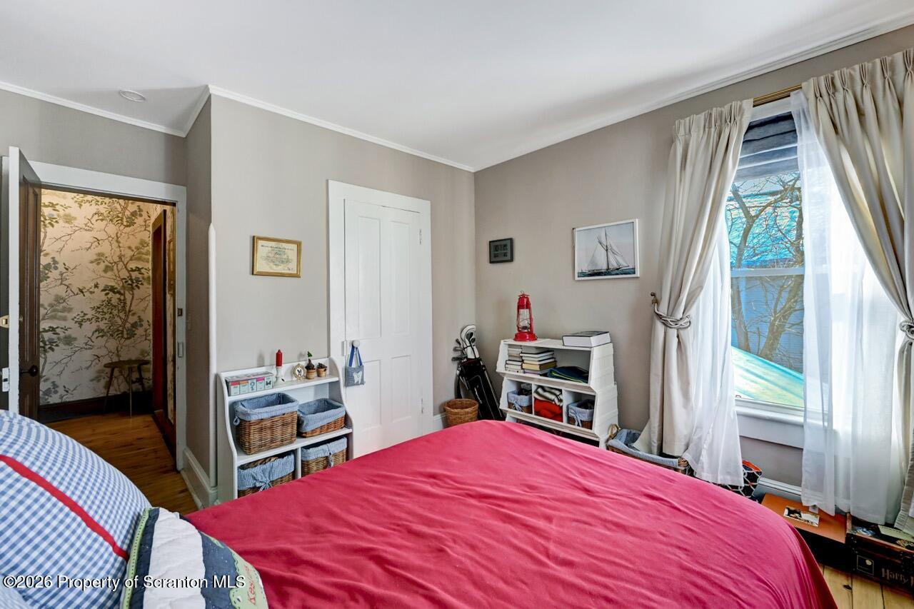 902 Columbia Street Scranton, PA 18509 - Photo 39 of 66 a bedroom with a bed and a dresser next to a window