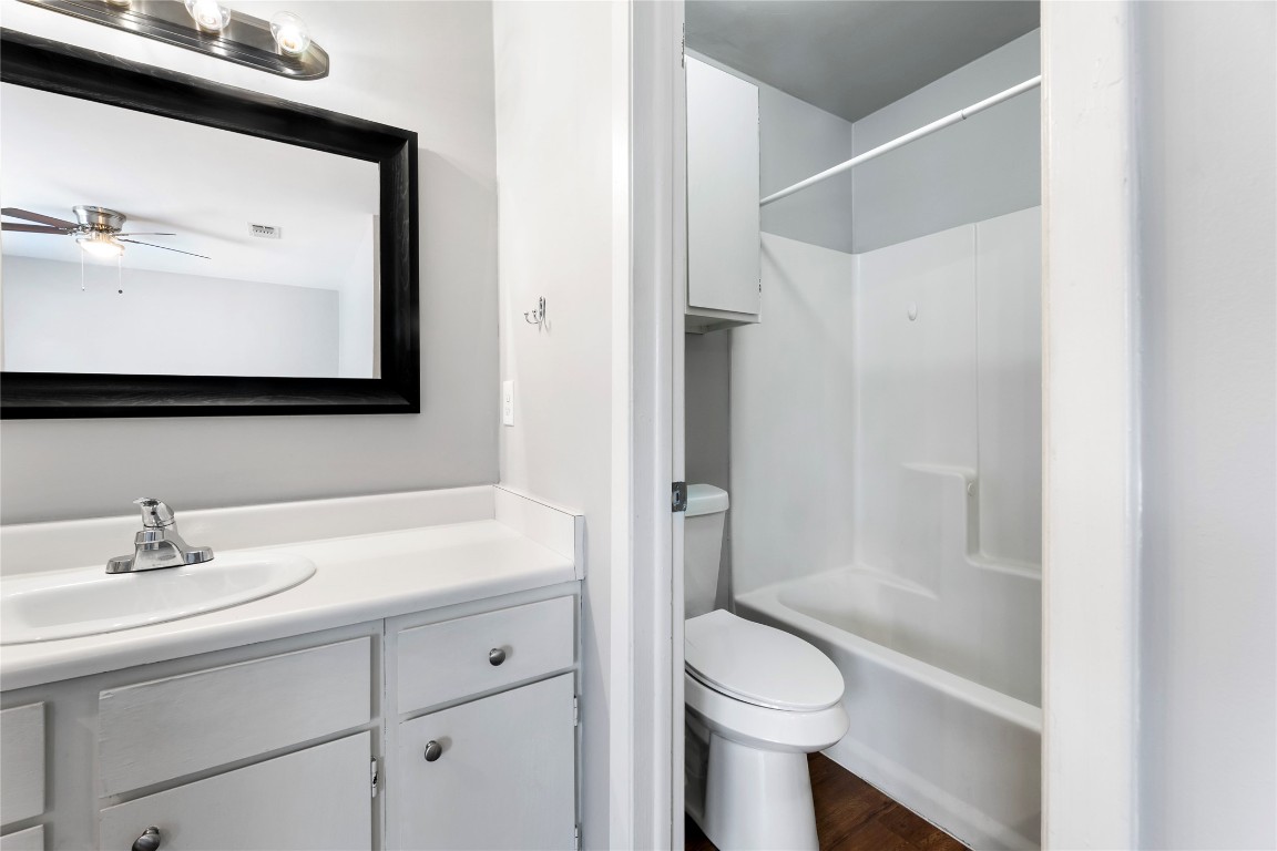 4304 Acropolis Court, Unit B Austin, TX 78759 - Photo 14 of 22 a bathroom with a sink a toilet and shower