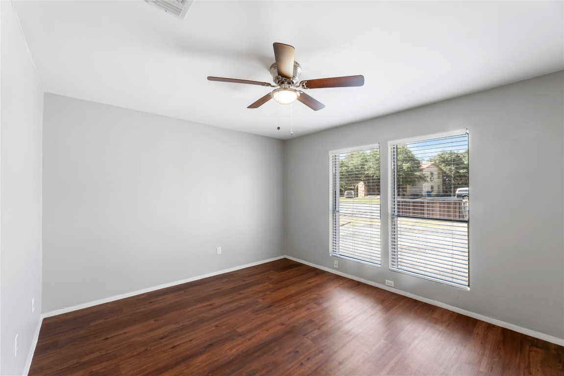 4304 Acropolis Court, Unit B Austin, TX 78759 - Photo 15 of 22 a view of empty room with wooden floor and fan