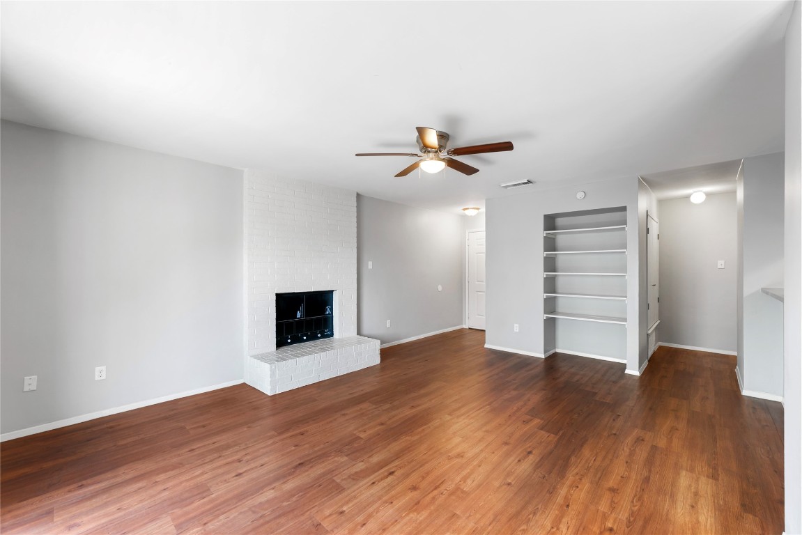 4304 Acropolis Court, Unit B Austin, TX 78759 - Photo 5 of 22 a view of an empty room with a ceiling fan and wooden floor