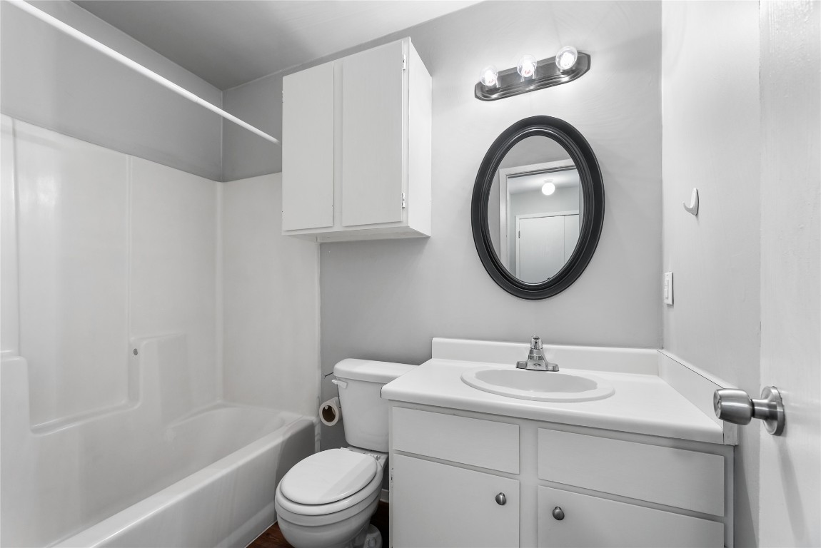 4304 Acropolis Court, Unit B Austin, TX 78759 - Photo 9 of 22 a bathroom with a sink a toilet and a mirror