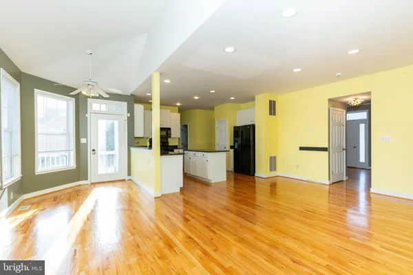 a kitchen with granite countertop a sink a counter top space appliances and cabinets