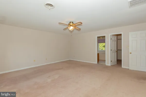 a bathroom with a bathtub a shower and a window