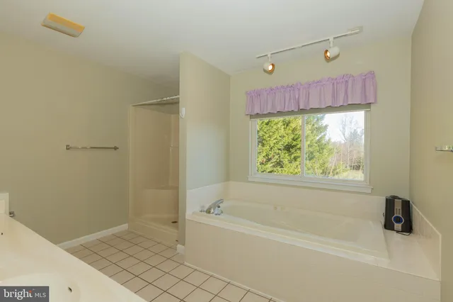 a view of a livingroom with a ceiling fan and window