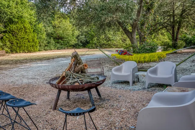 a backyard of a house with table and chairs
