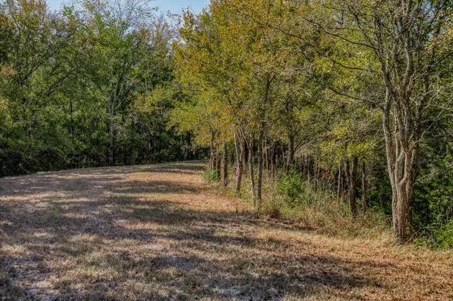 a swimming pool with outdoor seating and yard