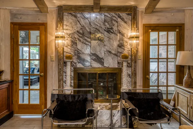 a living room with fireplace furniture and a window