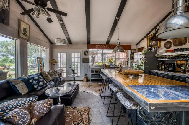 a kitchen with stainless steel appliances granite countertop a sink a stove and refrigerator