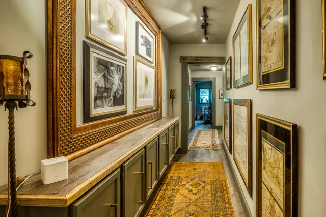 a living room with furniture a lamp and a chandelier