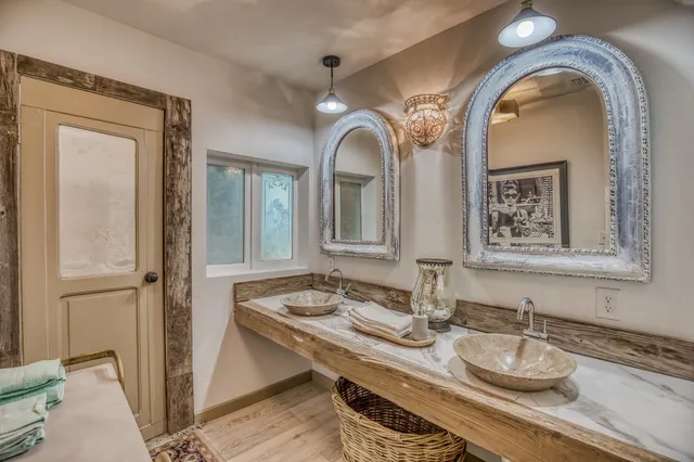 a bathroom with double vanity sinks and a mirror