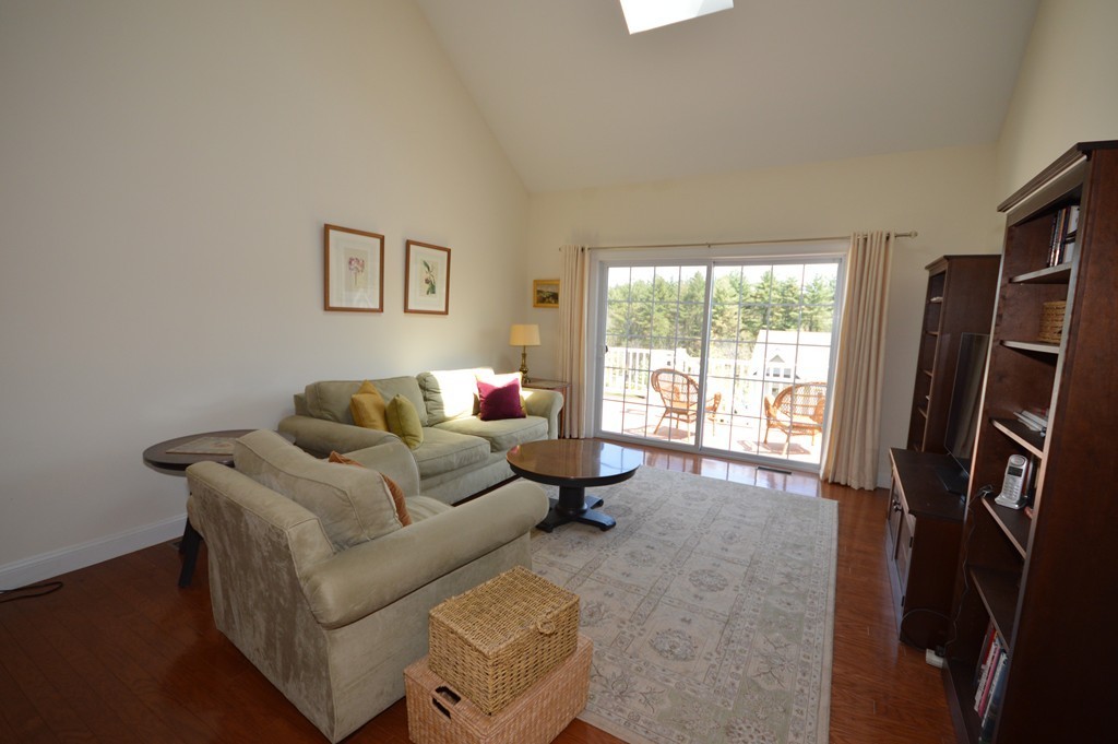 704 Autumn Ridge Drive, Unit 704 Ayer, MA 01432 - Photo 12 of 30 a living room with furniture a window and a flat screen tv