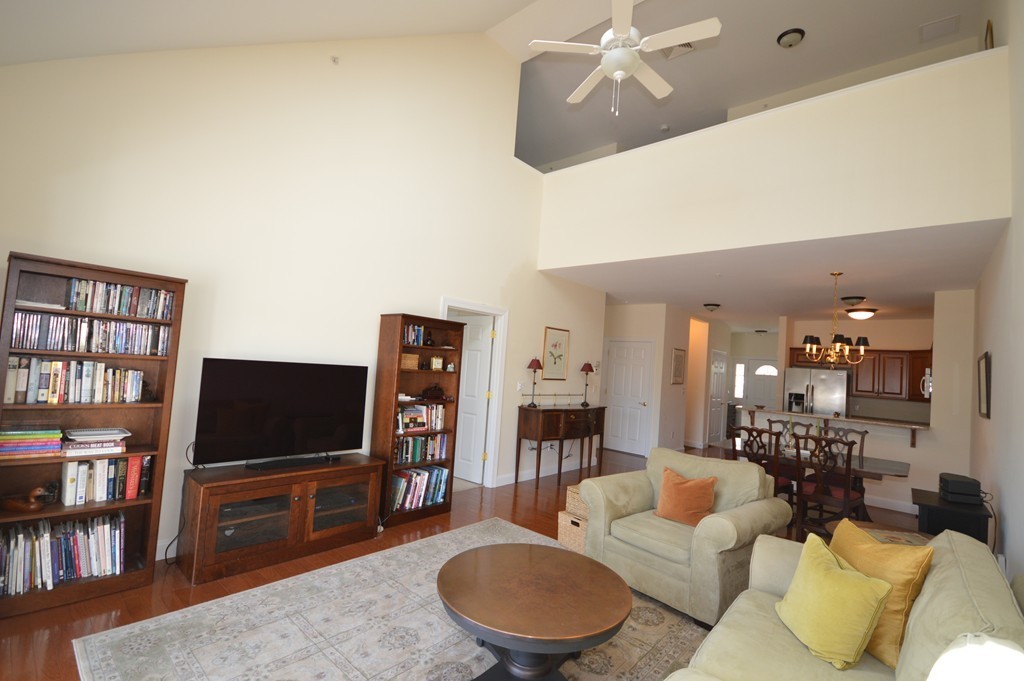 704 Autumn Ridge Drive, Unit 704 Ayer, MA 01432 - Photo 14 of 30 a living room with furniture and a flat screen tv