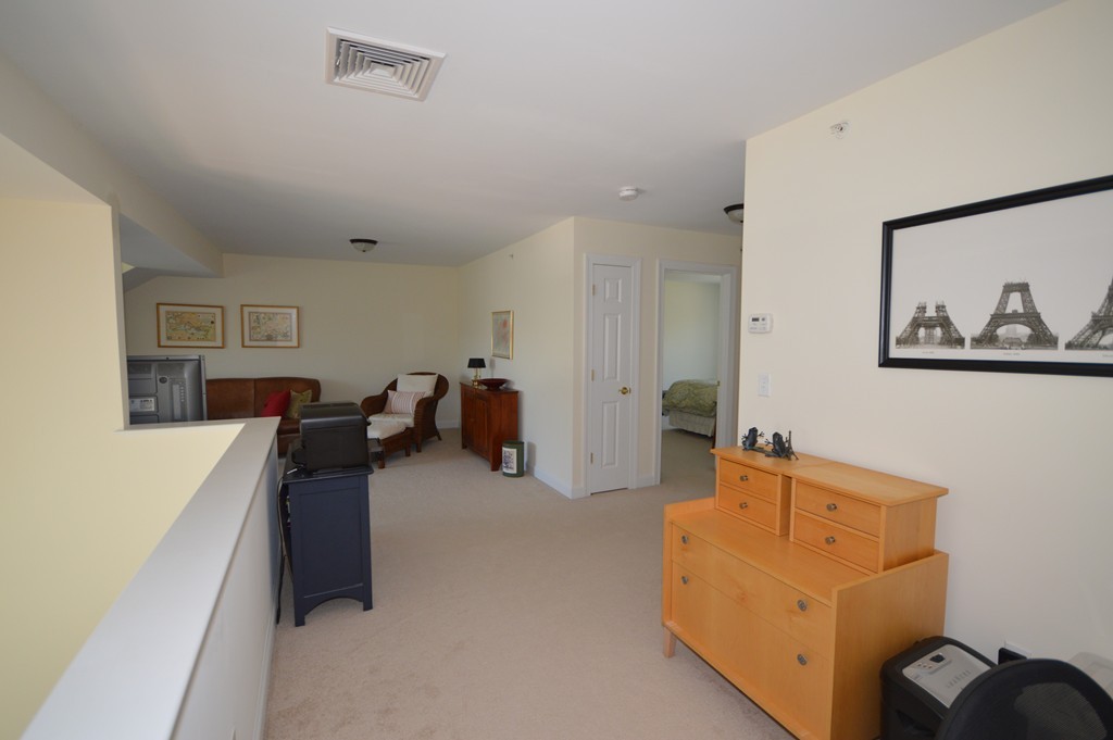 704 Autumn Ridge Drive, Unit 704 Ayer, MA 01432 - Photo 19 of 30 a bed room with furniture and a window