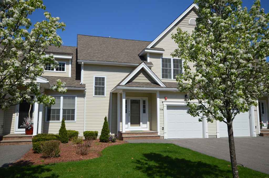 704 Autumn Ridge Drive, Unit 704 Ayer, MA 01432 - Photo 2 of 30 a front view of a house with garden