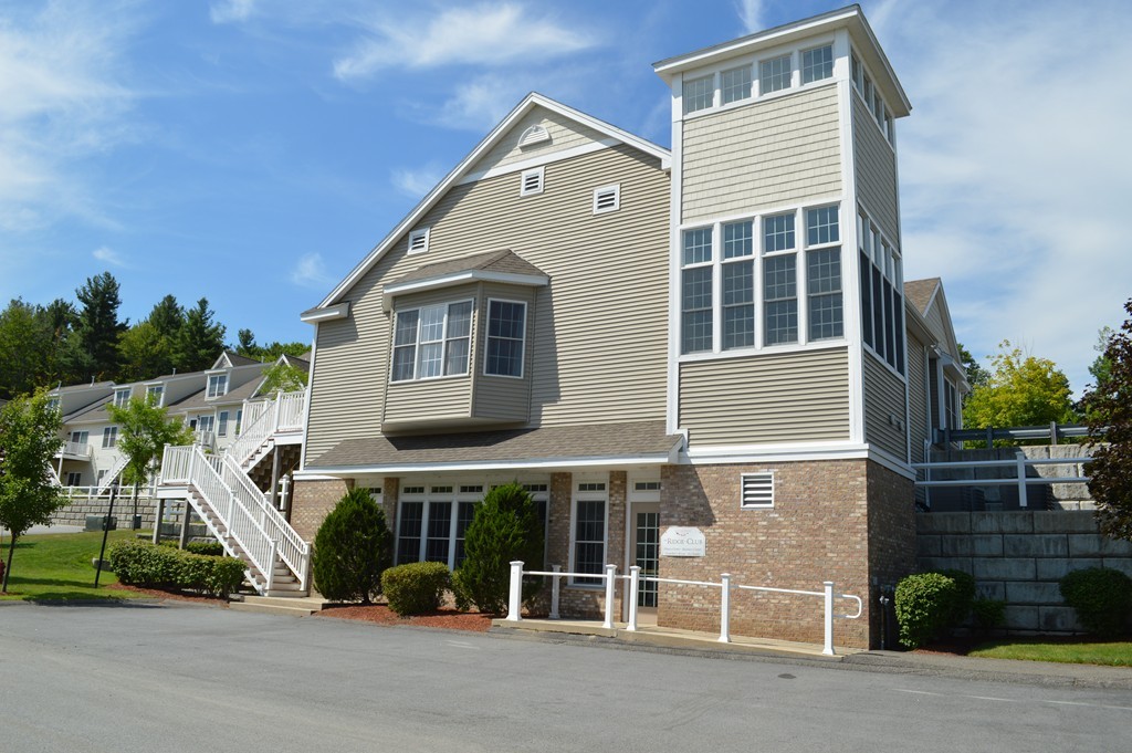 704 Autumn Ridge Drive, Unit 704 Ayer, MA 01432 - Photo 22 of 30 a front view of a house with a garden