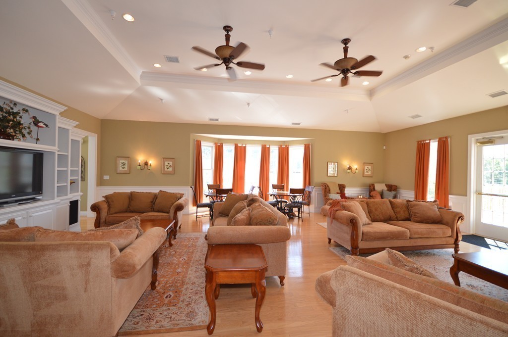 704 Autumn Ridge Drive, Unit 704 Ayer, MA 01432 - Photo 25 of 30 a living room with furniture and a large window