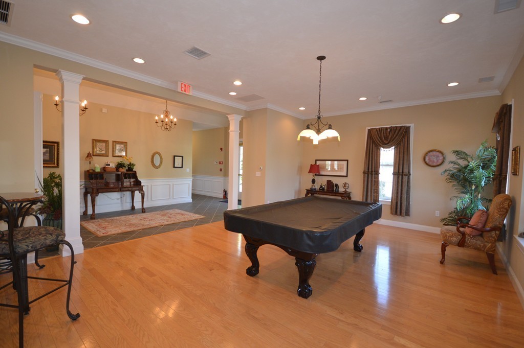 704 Autumn Ridge Drive, Unit 704 Ayer, MA 01432 - Photo 26 of 30 a room with furniture and wooden floor