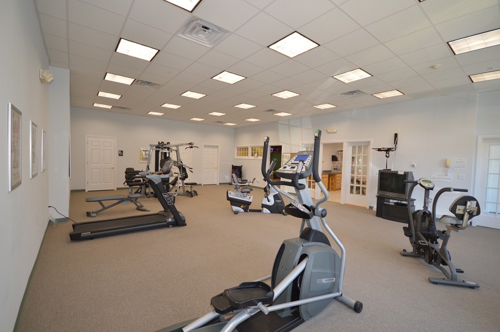 704 Autumn Ridge Drive, Unit 704 Ayer, MA 01432 - Photo 28 of 30 a view of a room with gym equipment