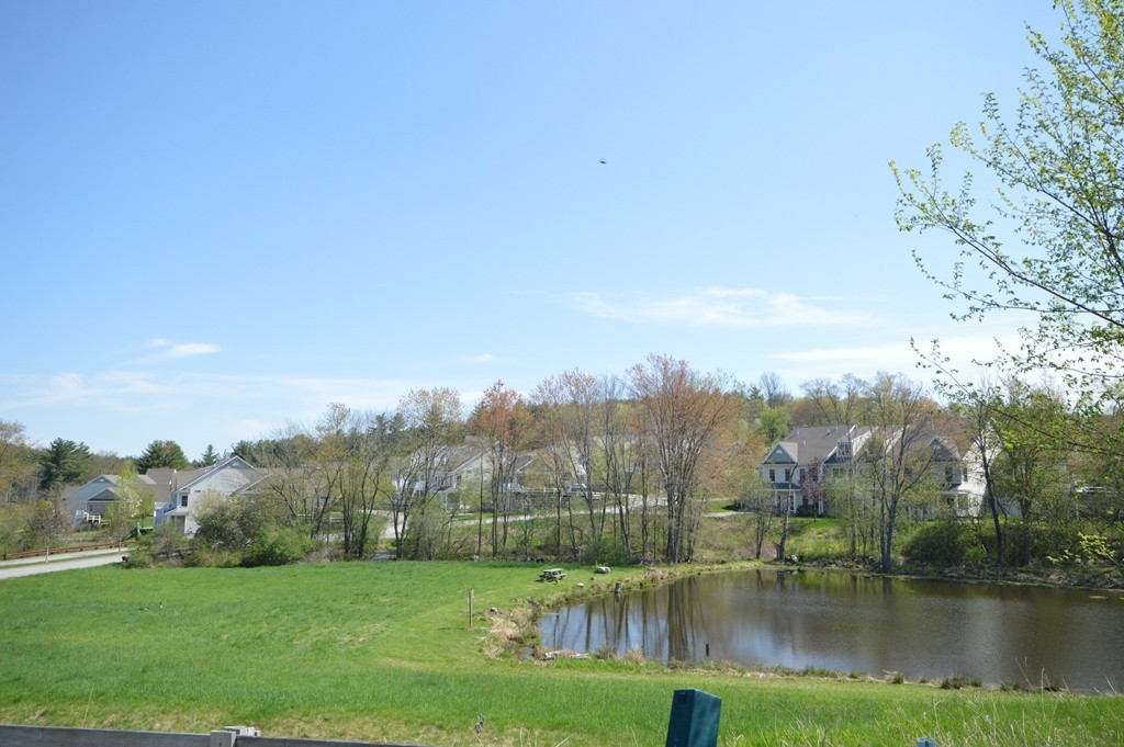 704 Autumn Ridge Drive, Unit 704 Ayer, MA 01432 - Photo 3 of 30 a view of lake with green space