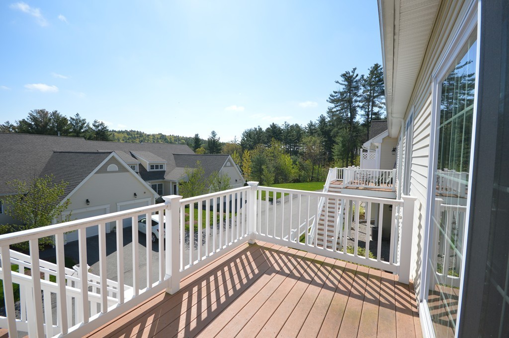 704 Autumn Ridge Drive, Unit 704 Ayer, MA 01432 - Photo 5 of 30 a view of a two chairs on the roof deck