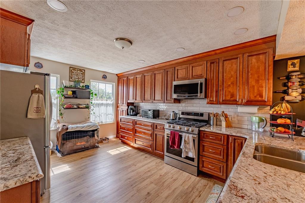 120 Lockheed Drive Coraopolis, PA 15108 - Photo 3 of 31 a kitchen with stainless steel appliances granite countertop a refrigerator stove top oven and sink