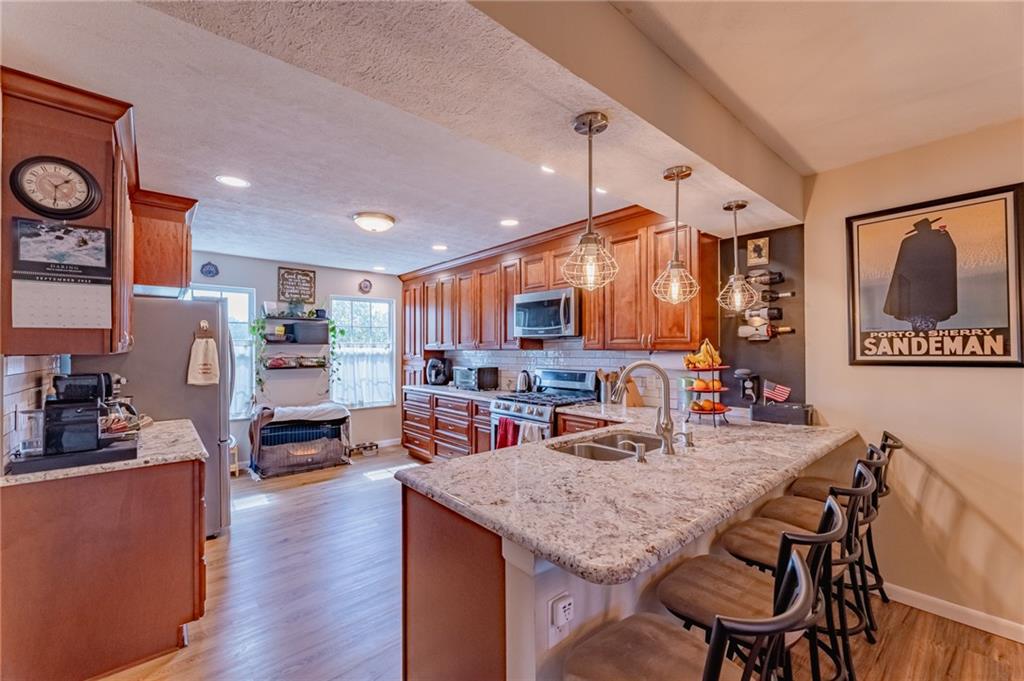 120 Lockheed Drive Coraopolis, PA 15108 - Photo 6 of 31 a kitchen with stainless steel appliances granite countertop a table chairs and a refrigerator