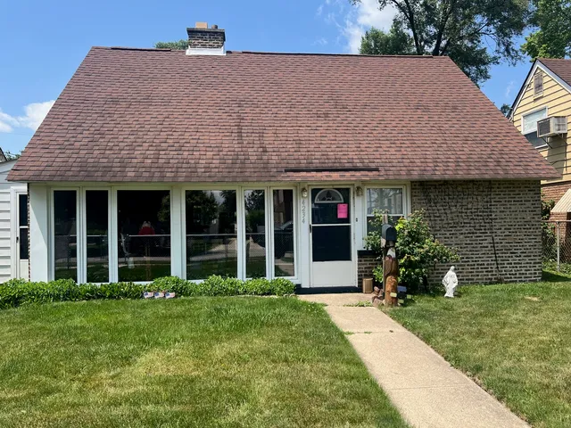 a front view of a house with garden and porch