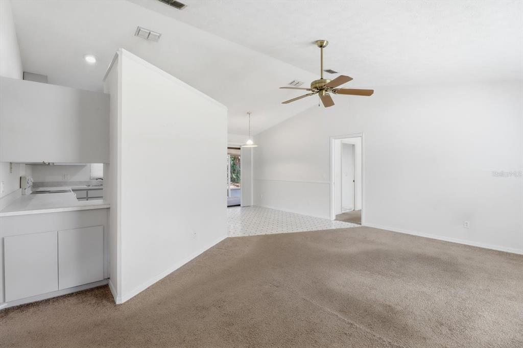 6355 East Rush Street Inverness, FL 34452 - Photo 5 of 27 a view of a kitchen with a sink cabinetry and a ceiling fan